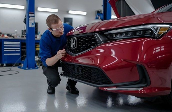 Auto Body technician looking at a Honda Sedan for repair at Alioto’s Auto Body San Francisco Bay Auto-Body-technician-looking-at-a-Honda-Sedan-for-repair-at-Aliotos-Auto-Body-San-Francisco-Bay