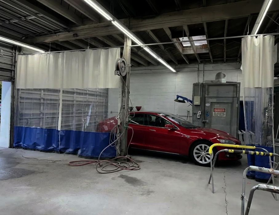 Tesla sitting in shop at Alioto’s Auto Body San Mateo Rivian-on-a-lift-for-a-Certified-Inspection-Aliotos-Auto-Body-San-Mateo