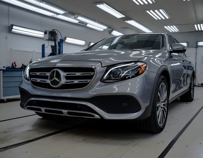 Mercedes-car-in-body-shop-Benefits-of-Aliotos-Certified-Collision-Repair customers-next-to-blue-bmw-after-bmw-certified-collision-repair-at-Aliotos-Auto-Body-San-Francisco